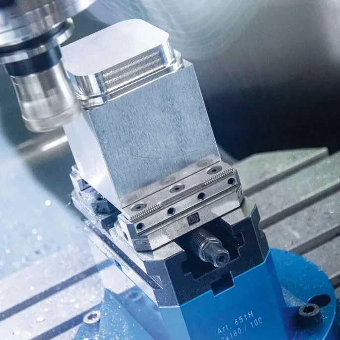 Gerardi vise clamping an aluminum part inside a 5-axis machining center