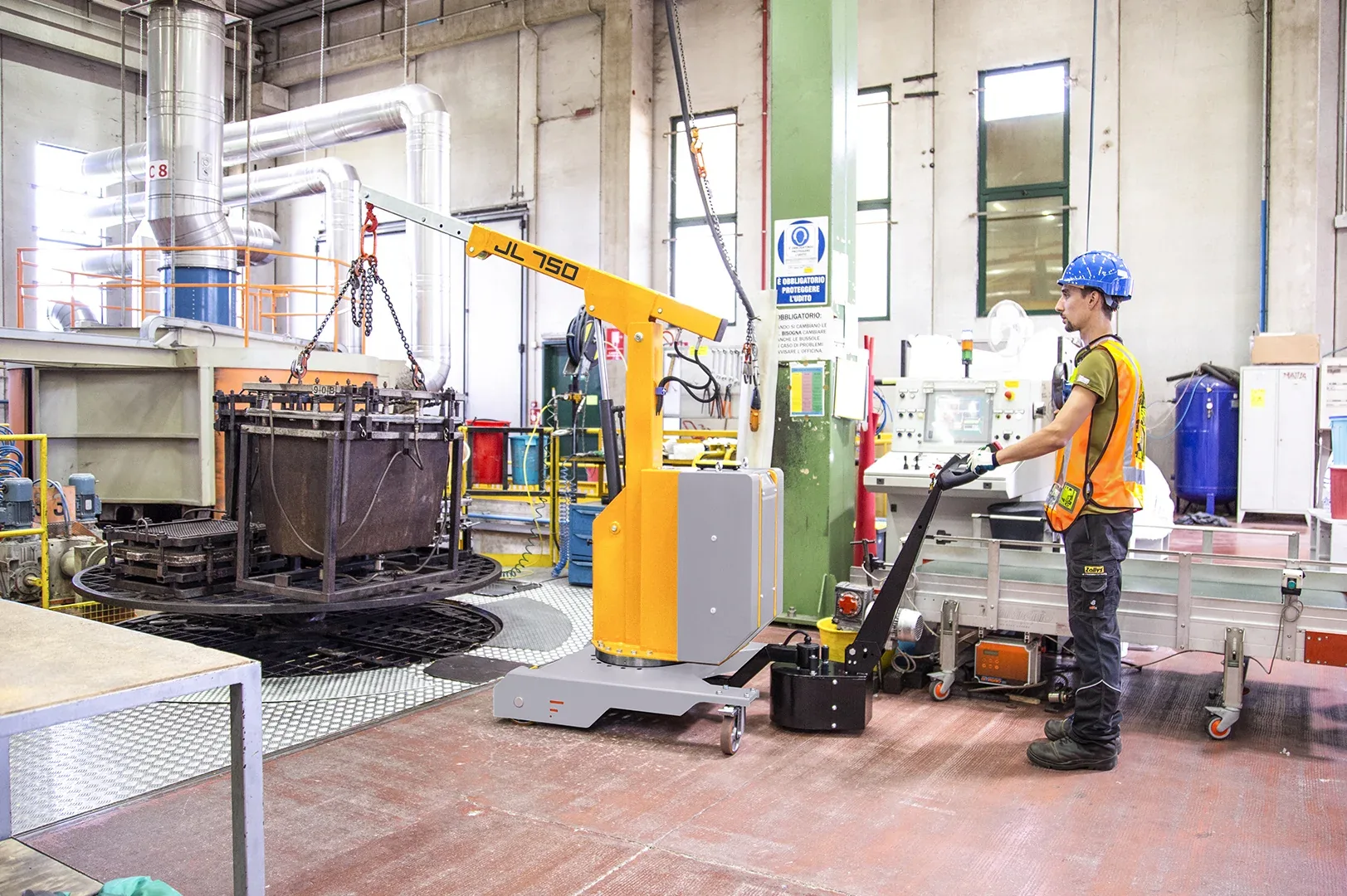 Operator driving a Just Lift JL750 counterbalanced mini crane in a plant