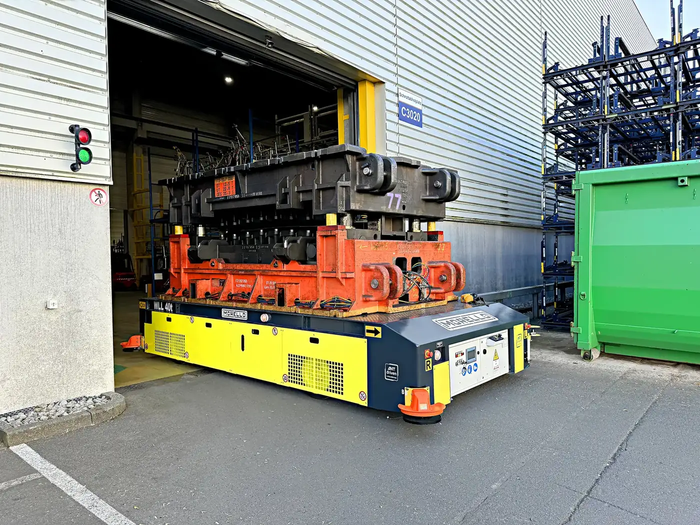 Morello AGV carrying a large die out of a loading bay