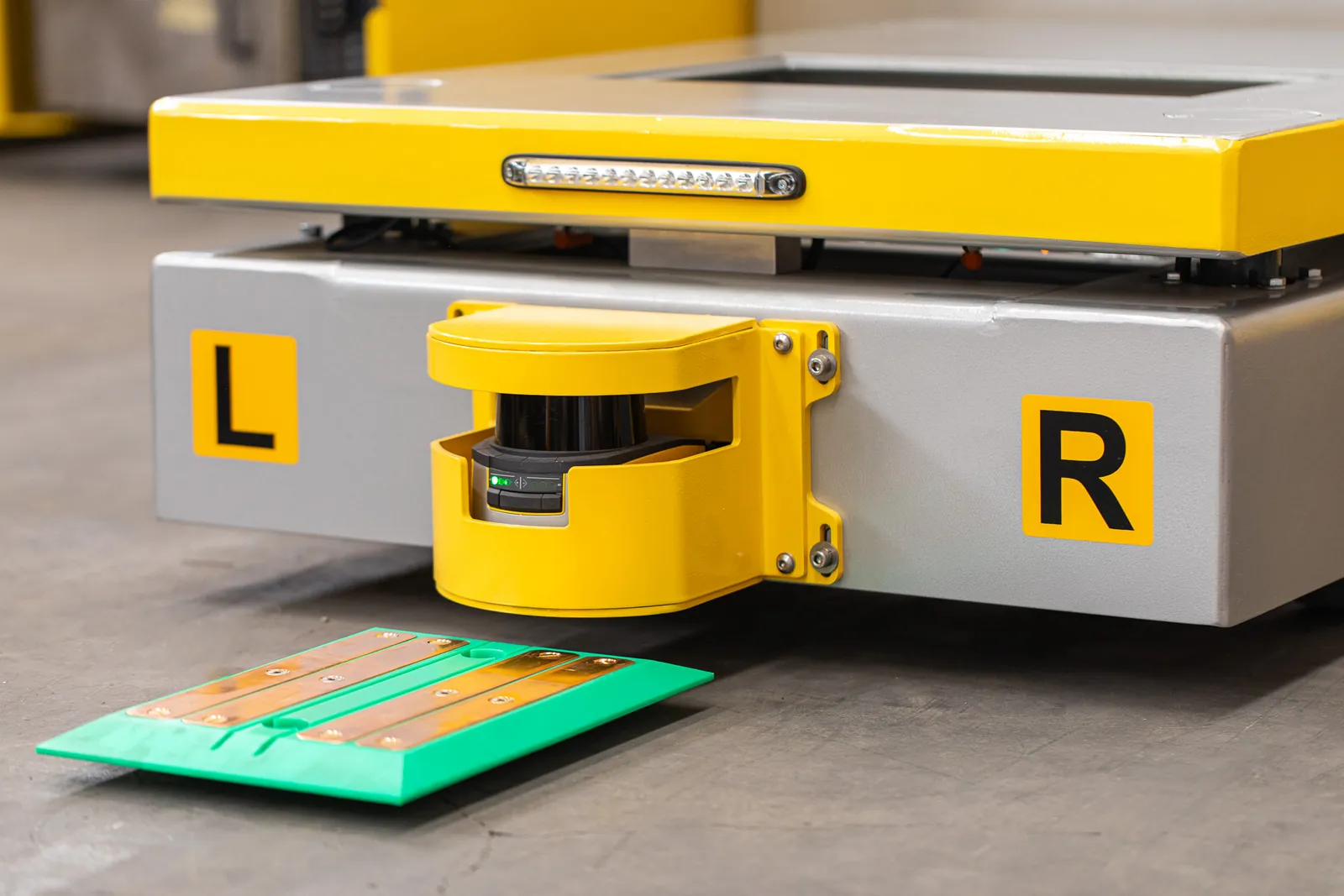 Close-up of the safety laser scanner and status light bar on a Morello AGV