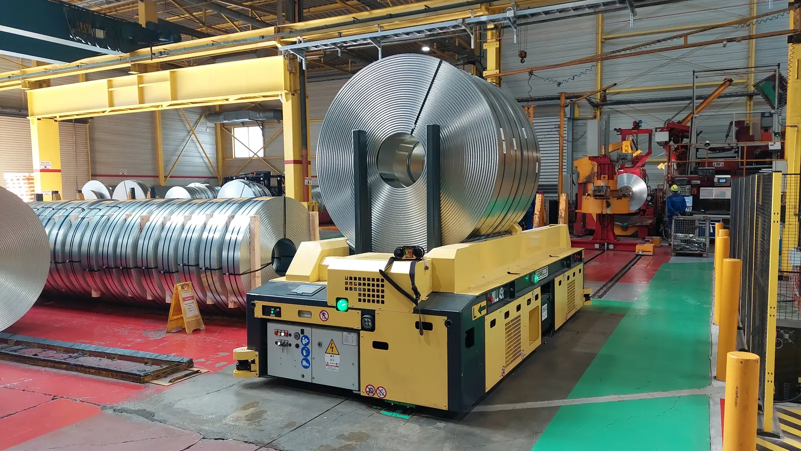 Morello AGV with coil cradle moving between steel coils