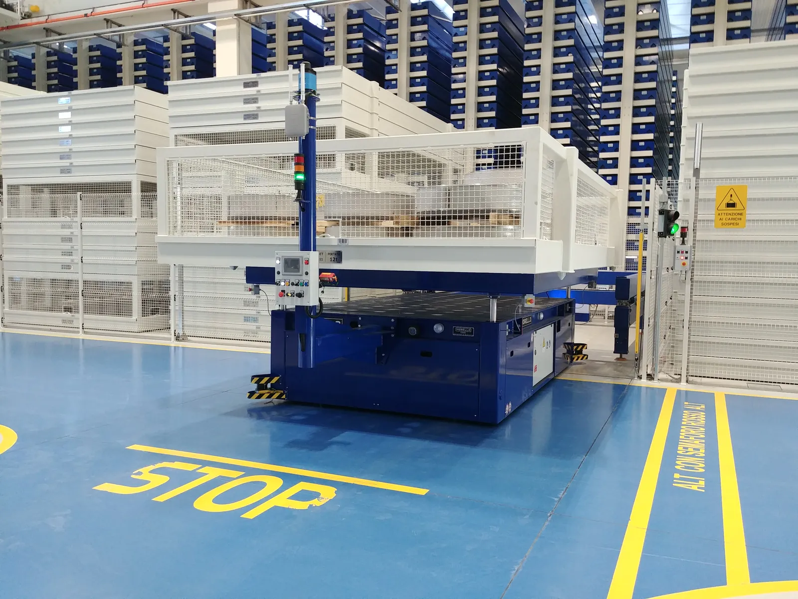 Morello AGV stopped at a marked STOP zone in an automated warehouse