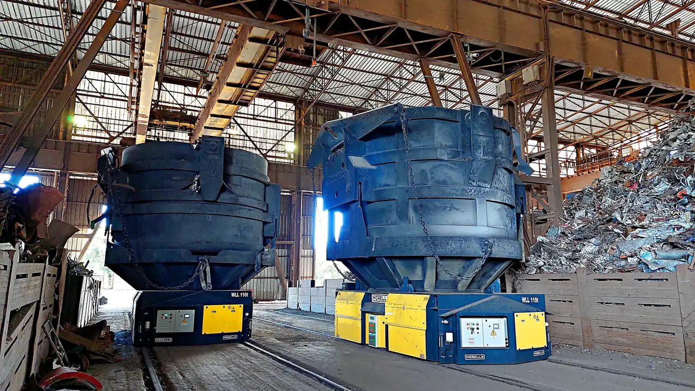 Two Morello rail carts carrying ladles in a melt shop