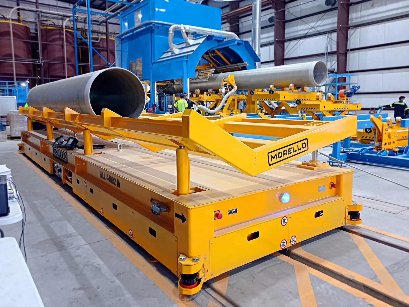 Morello rail transfer cart with cradles carrying large steel pipes