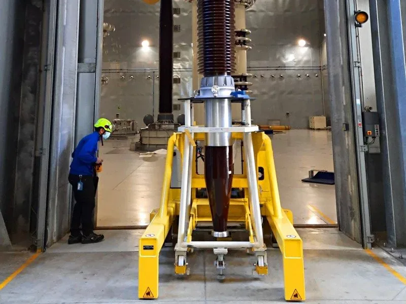 Morello 3 t mover with forks carrying a power transformer bushing in a test hall