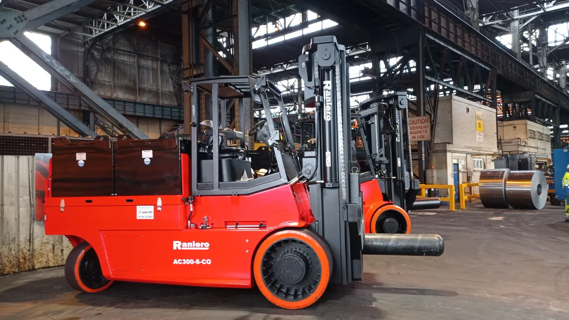 Raniero 30-ton AC electric forklift handling a steel coil