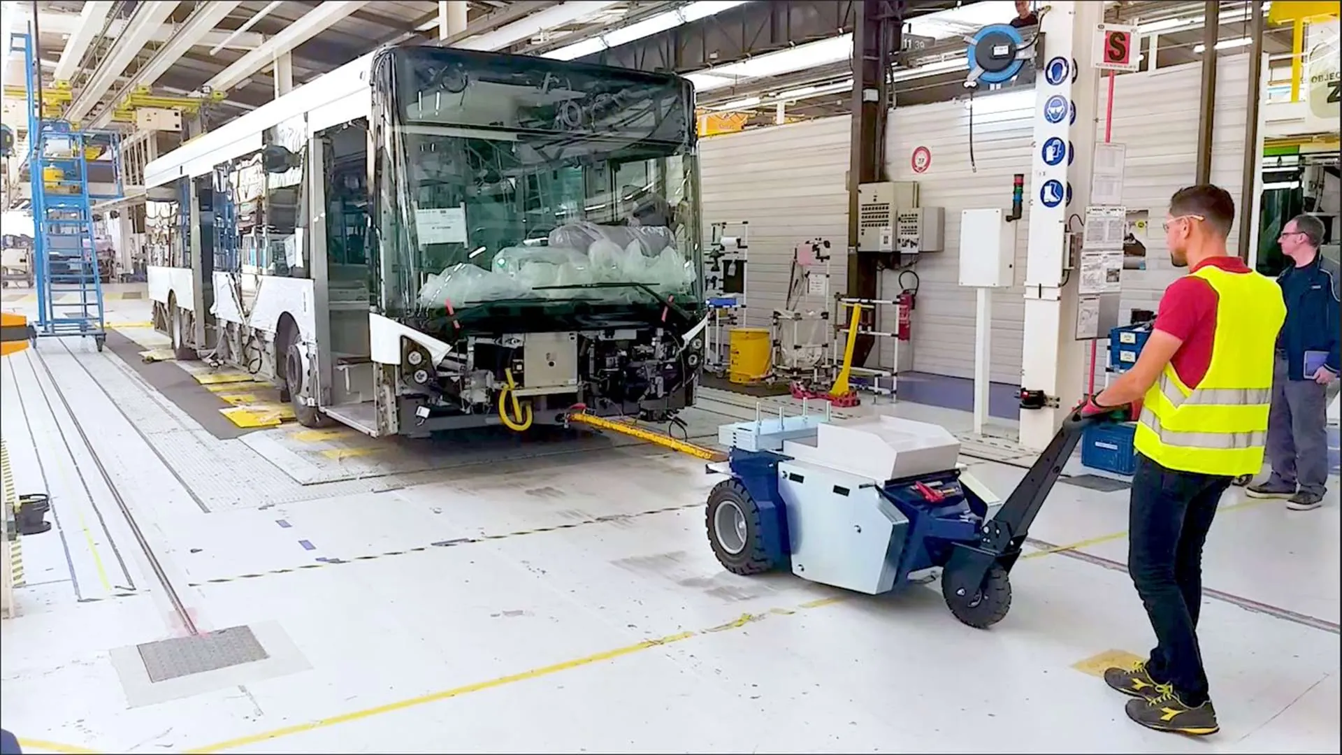 Zallys M10 electric tugger moving a bus in a final assembly and testing area